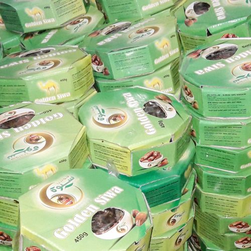 front view xurma brown tasty along with different nuts on the dark background